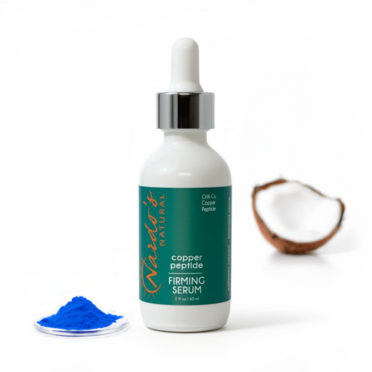 Copper peptide firming serum bottle with blue powder and coconut on a white background