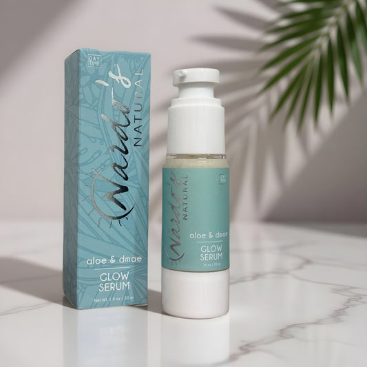 Glow Serum 1 oz bottle aside blue retail box on a marble countertop