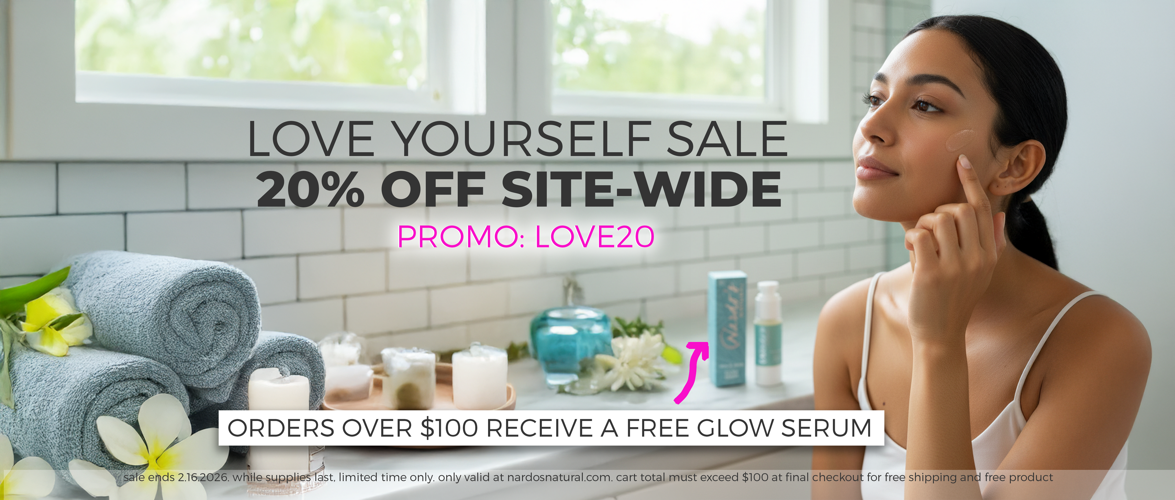 Woman applying face serum in bathroom with skincare and candles on the counter - text reads Love Yourself Sale 20% off Site-Wide, Promo: LOVE20. Orders over $100 receive a free Glow Serum. 
